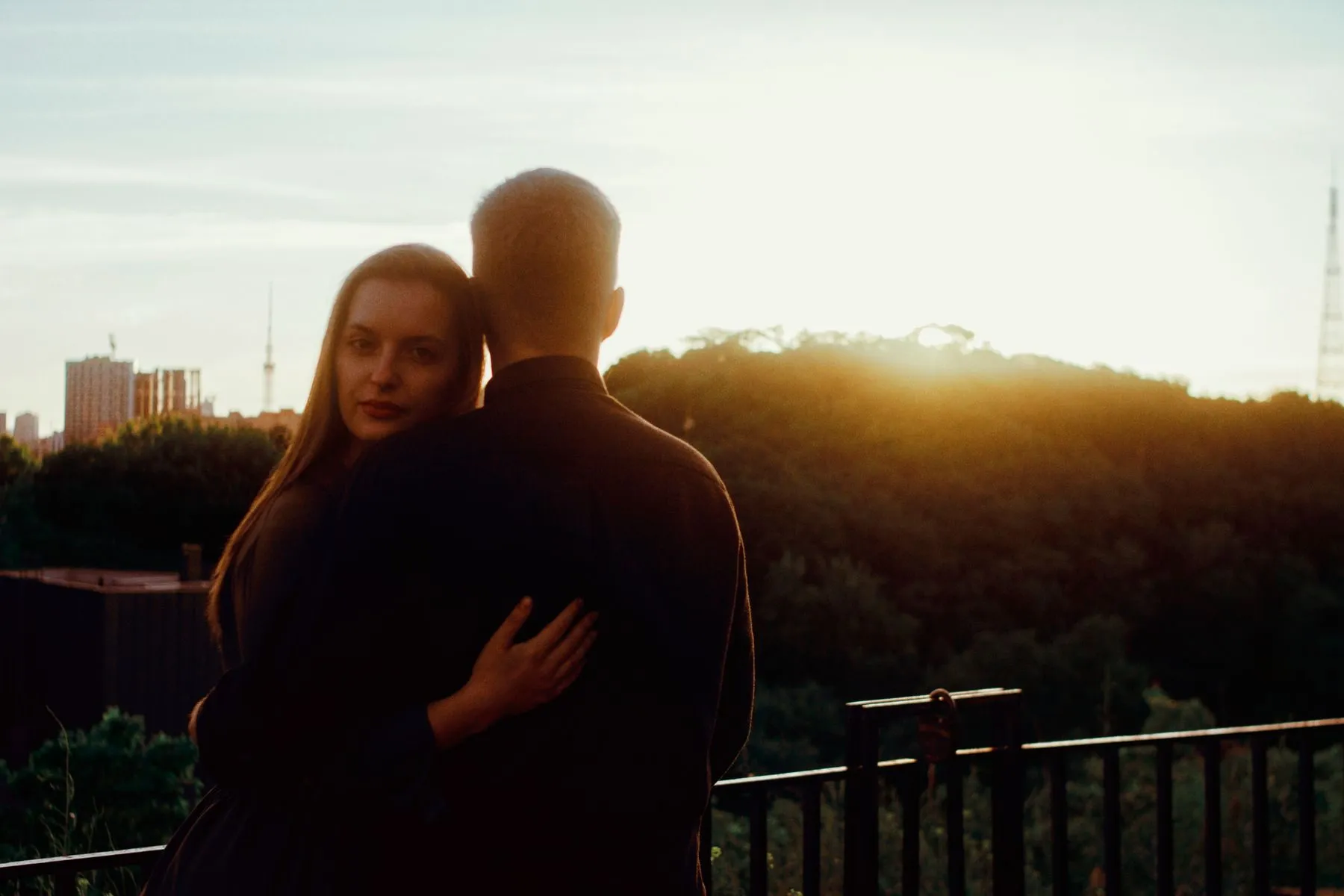 Couple on the balcony of their new home at sunset